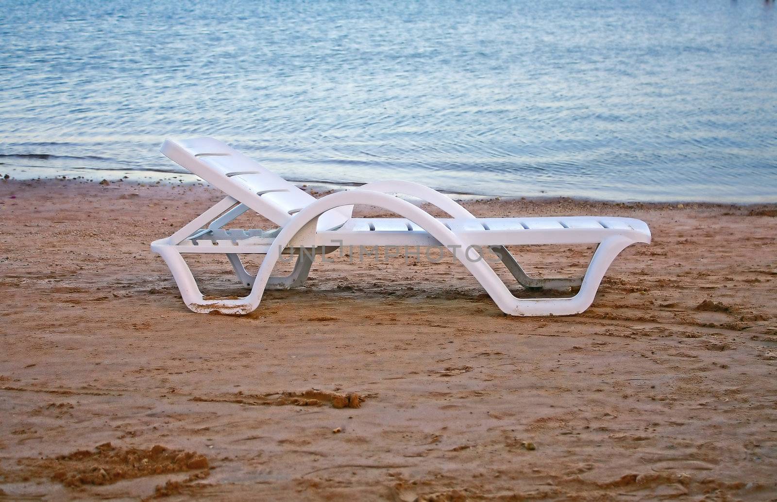 Egypt. Chaise stands on the sand at the beach.