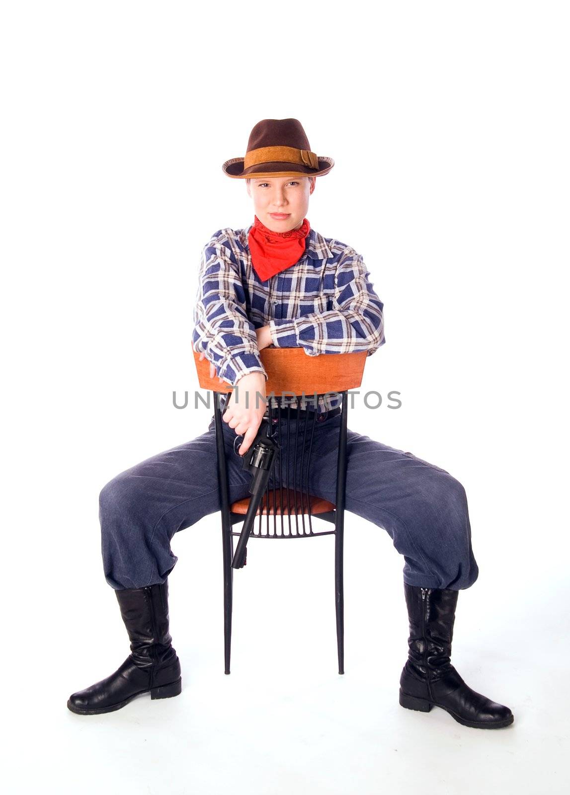 Cowgirl with gun siiting on chair and glares down upon all with the utmost contempt (isolated on white)