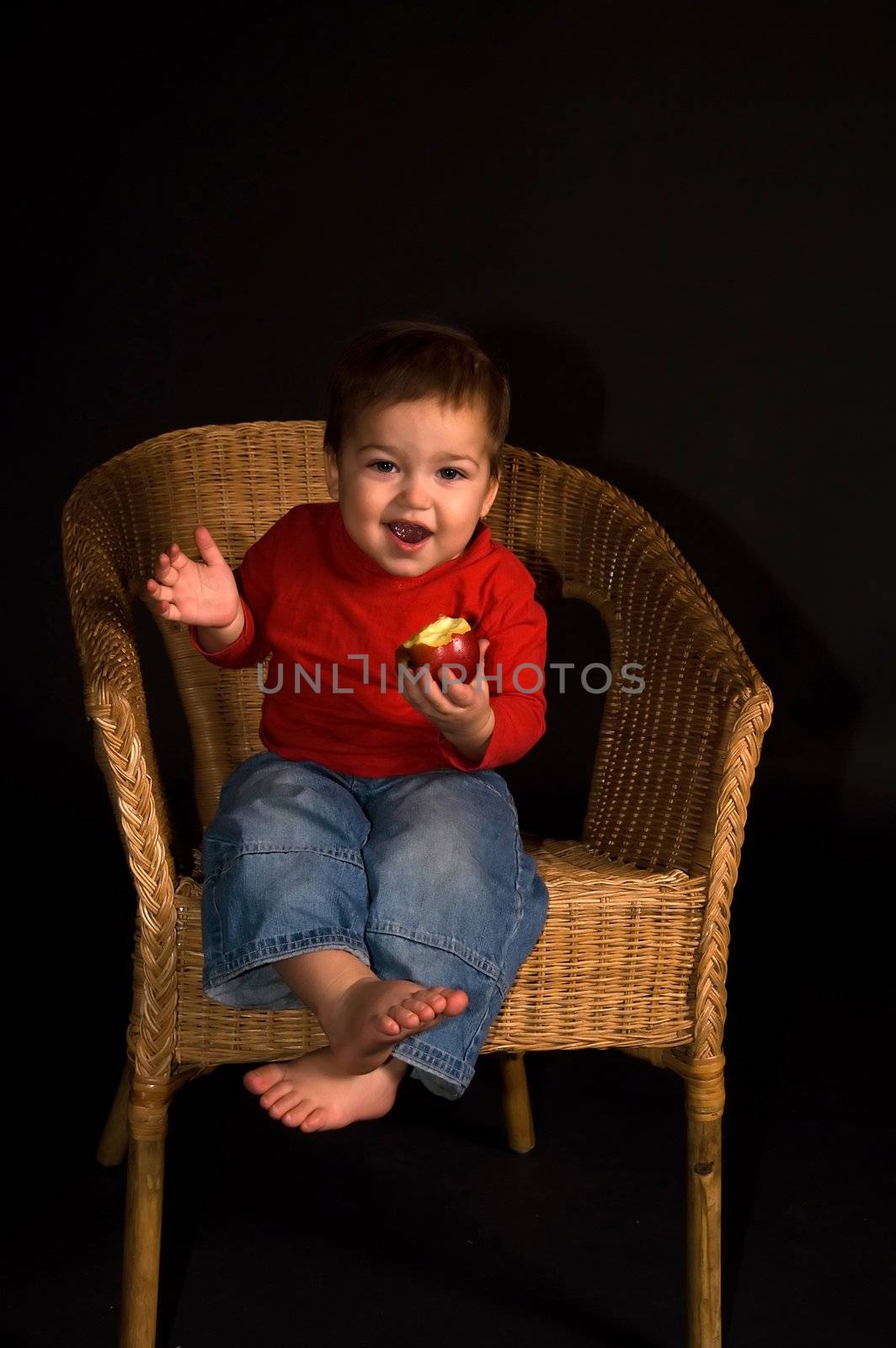 Boy sitiing in armchair, eating apple and shouting by lilsla