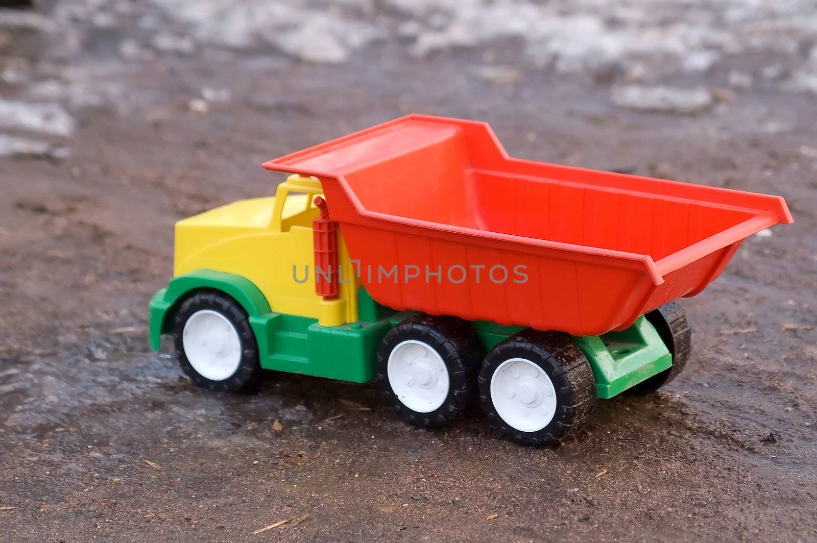 Baby toy dump truck in dirt by lilsla