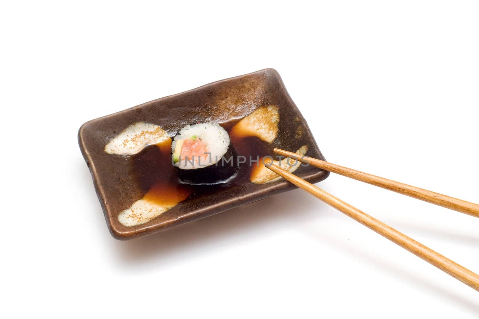 Salmon roll with avocado in soy (isolated on white)