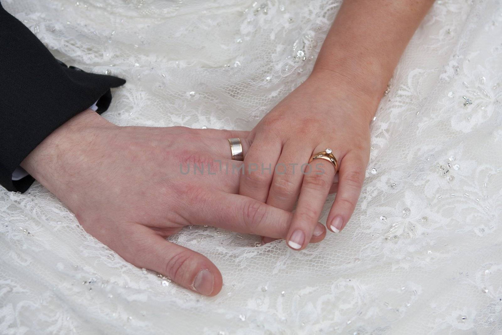 Couple holding hands on their wedding day