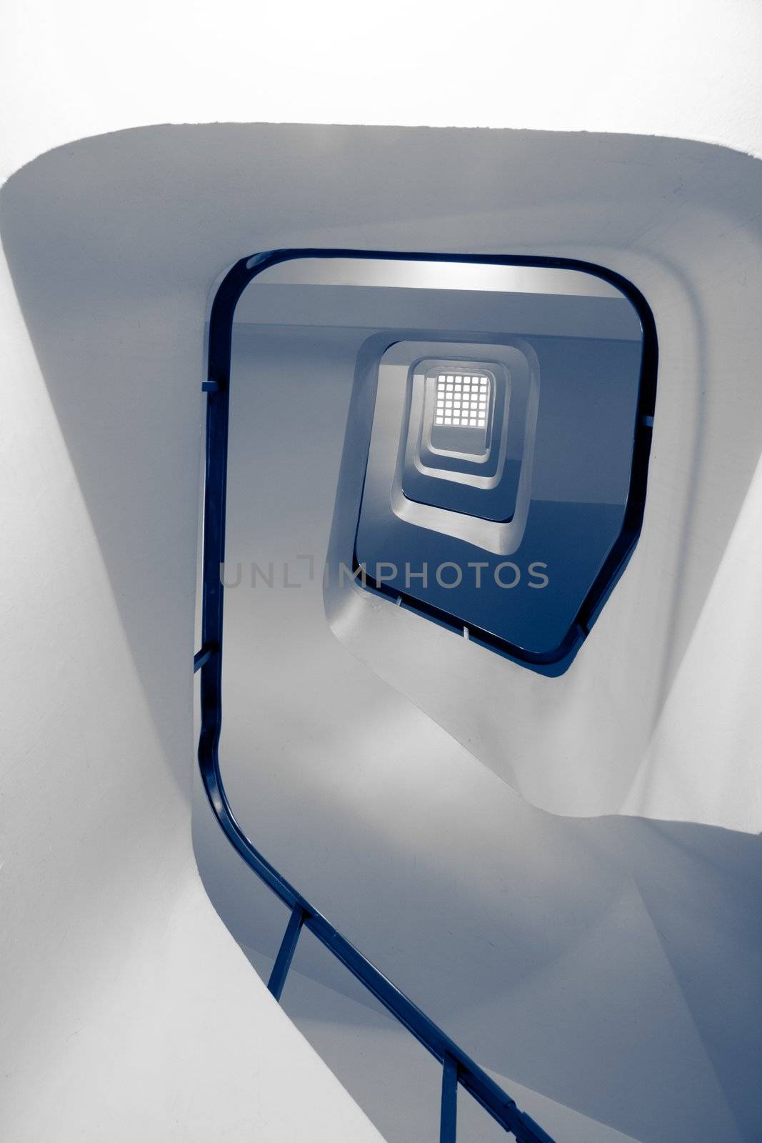 Staircase in building with handrail, toned in blue