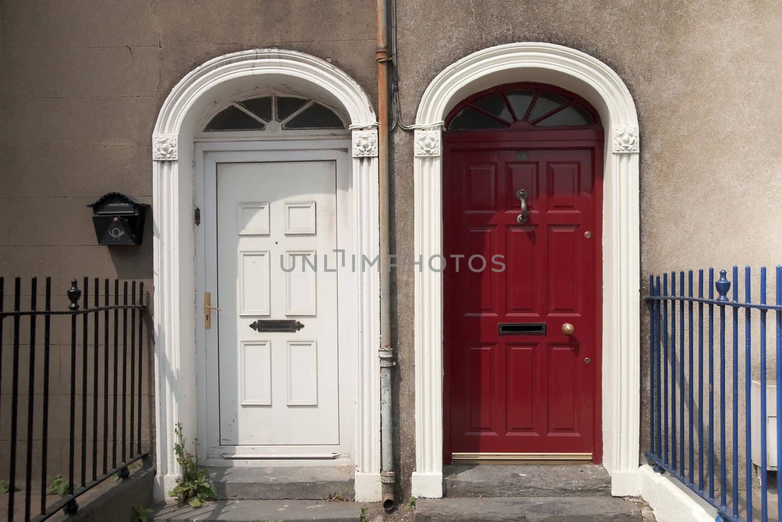 Two doors side by side, one red and one white