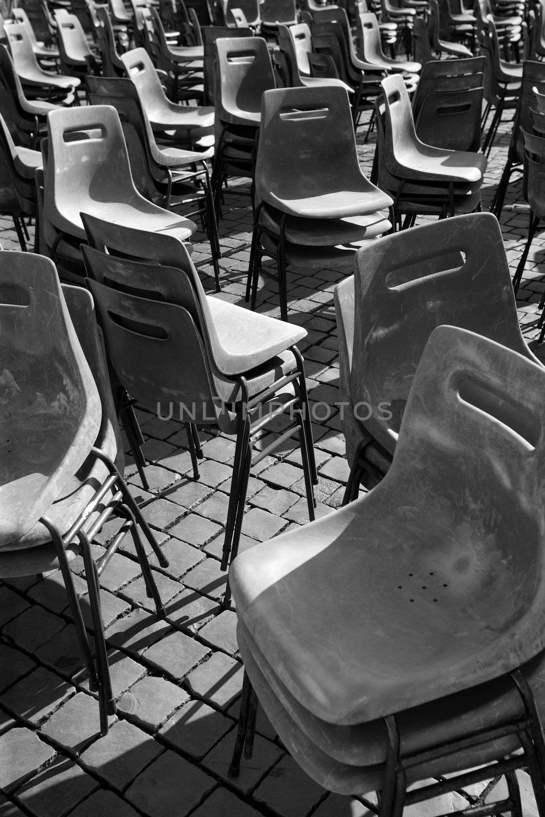 Stacked plastic chairs in Vatican city after the Pope made an appearance.
