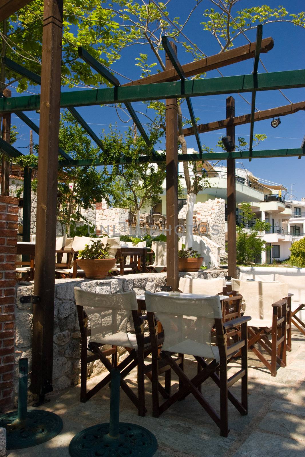 Shaded greek cafe terrace at sunny day