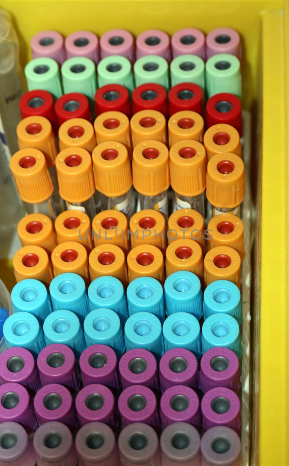 a colorful tray of medical syringes