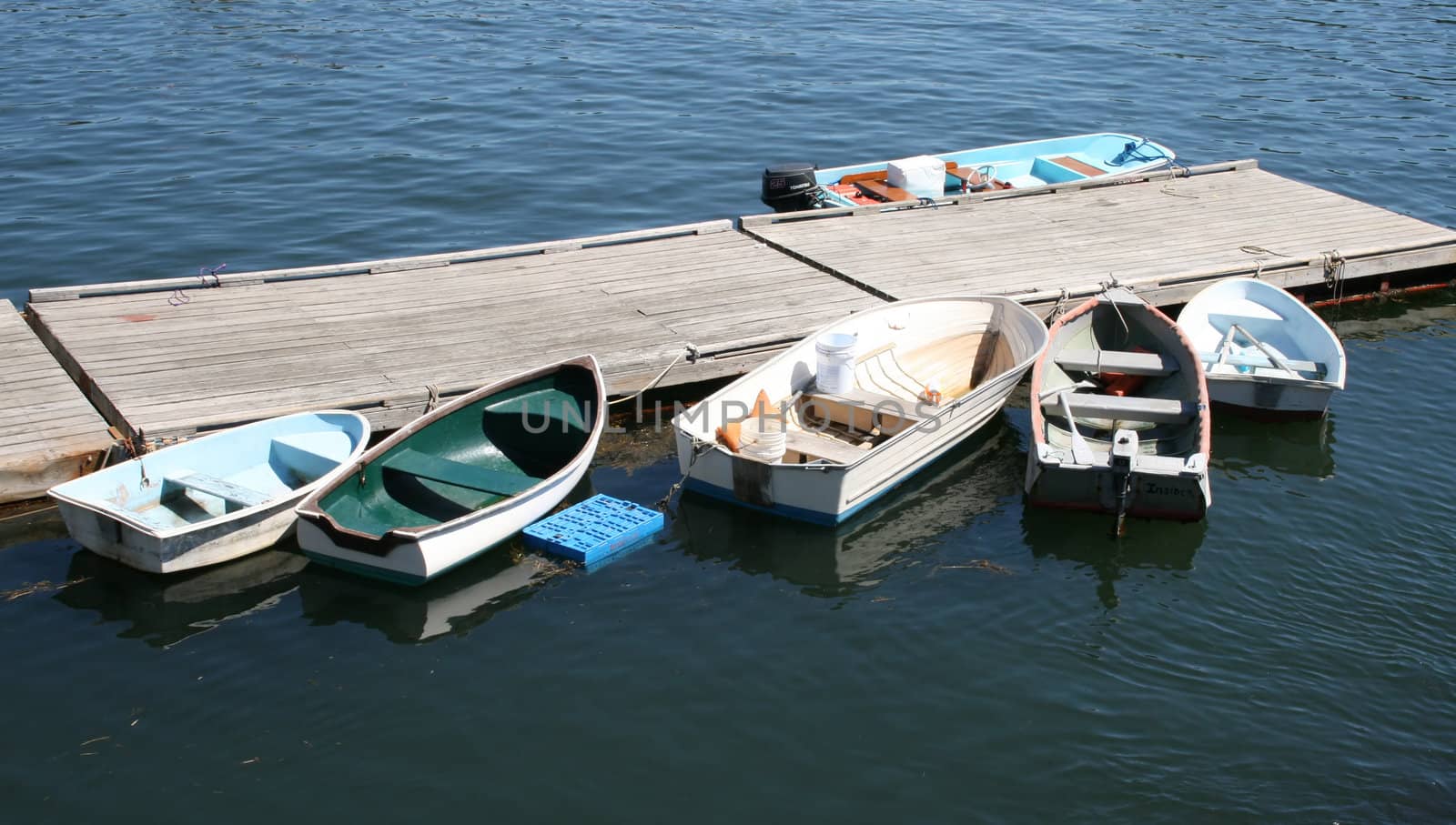 six skiffs, tied up at dock