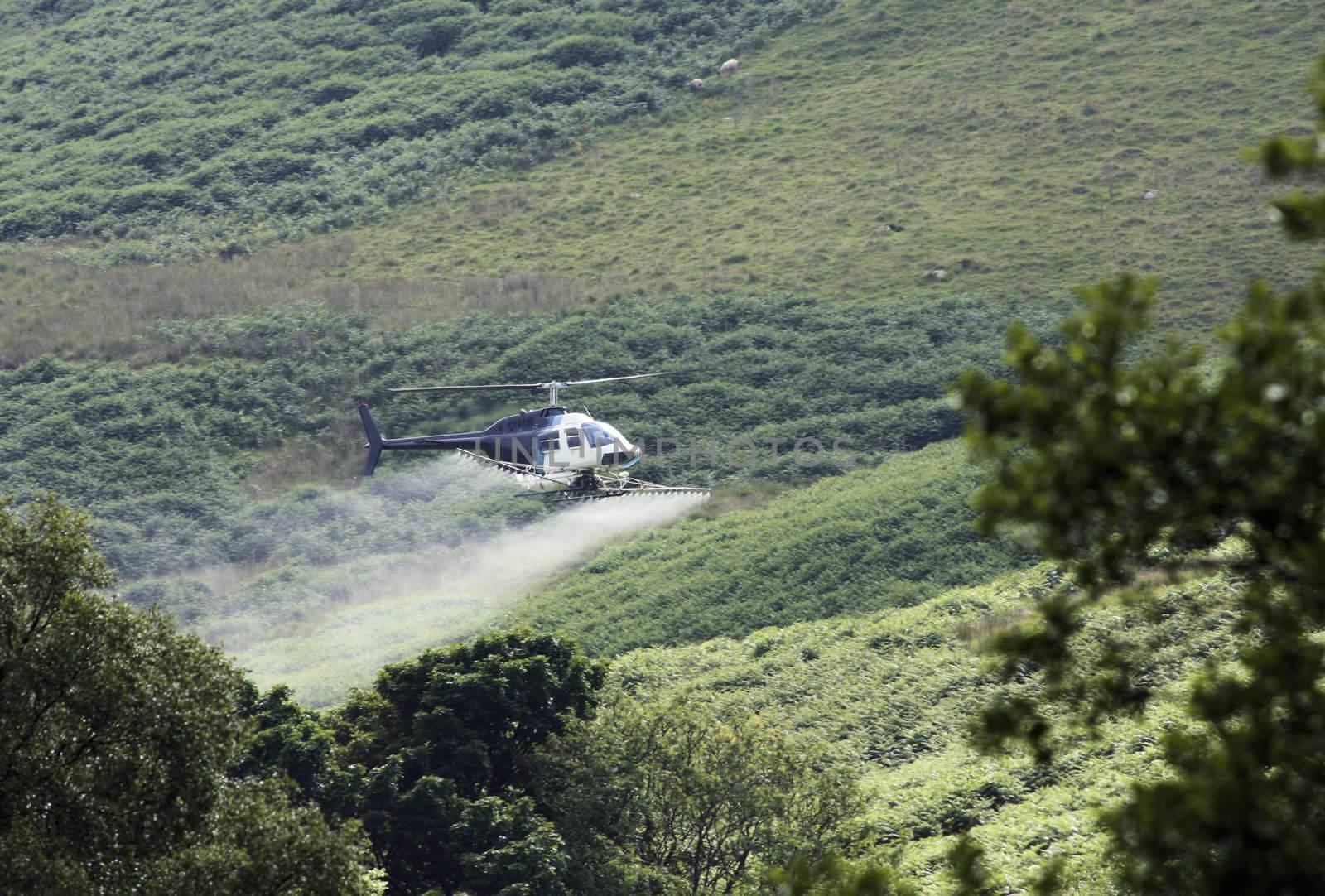 Crop sprayer duster helicopter, mountains, fields and land