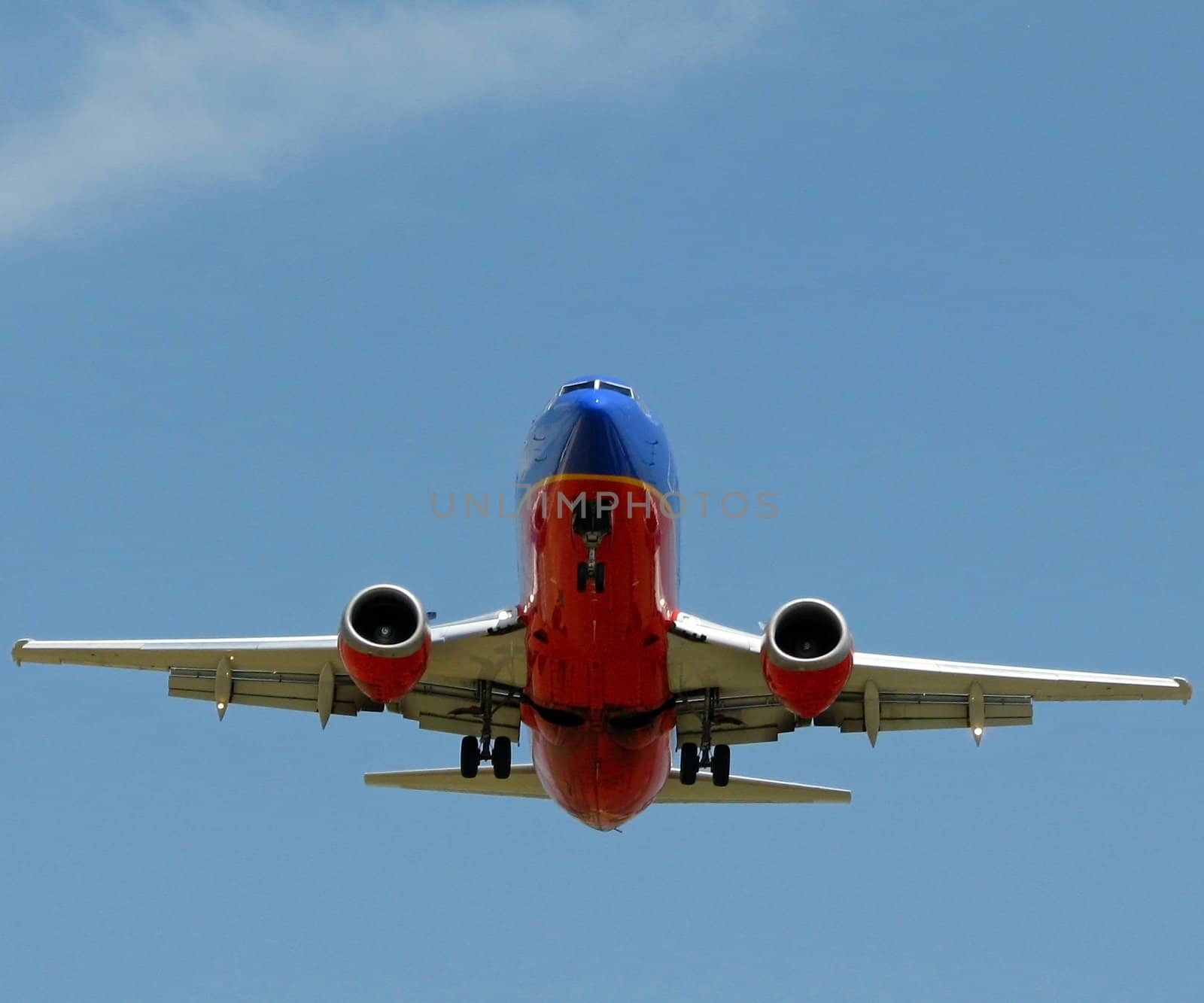 A 737 plane with the landing gears down.
