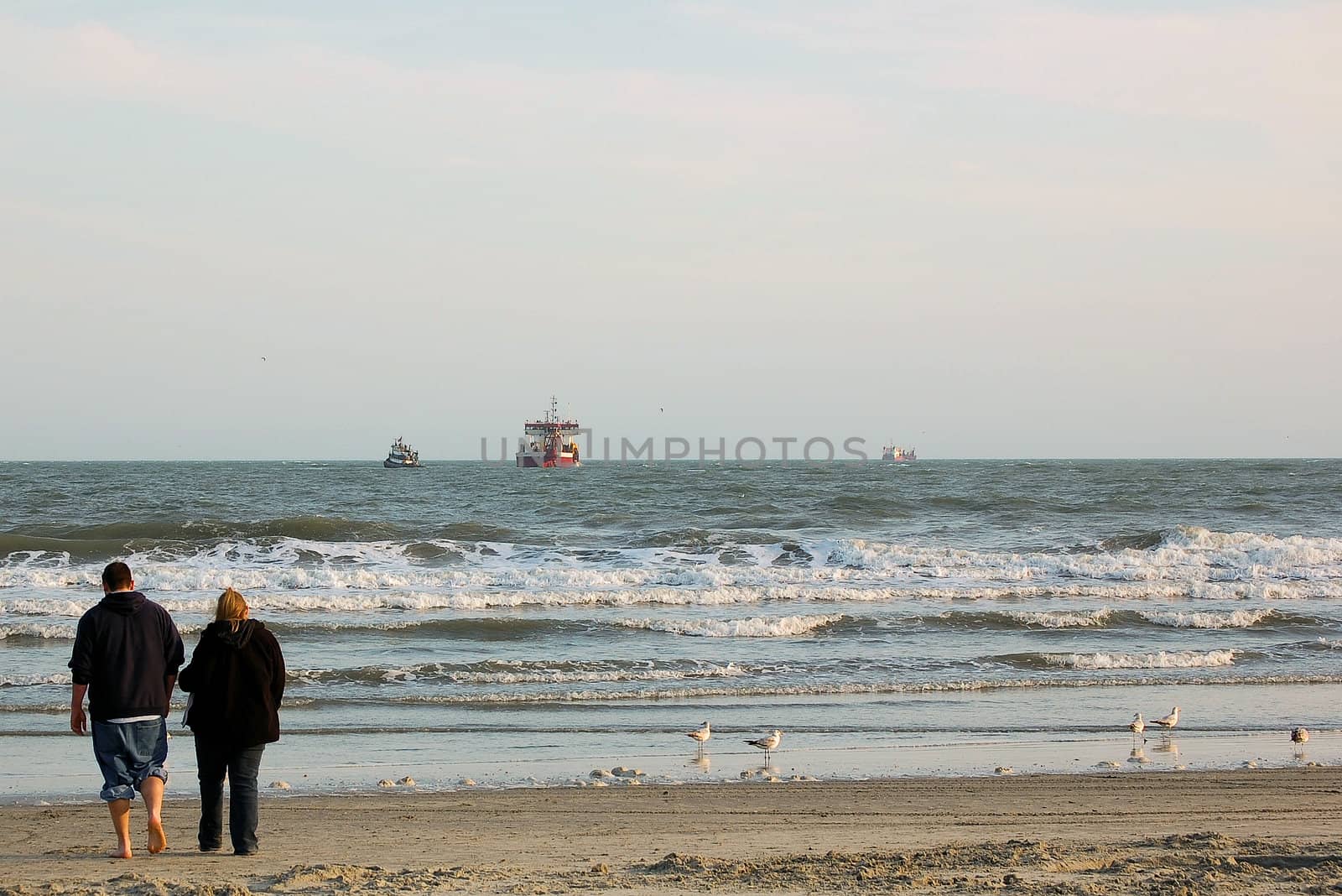 Couple walks together on the beach