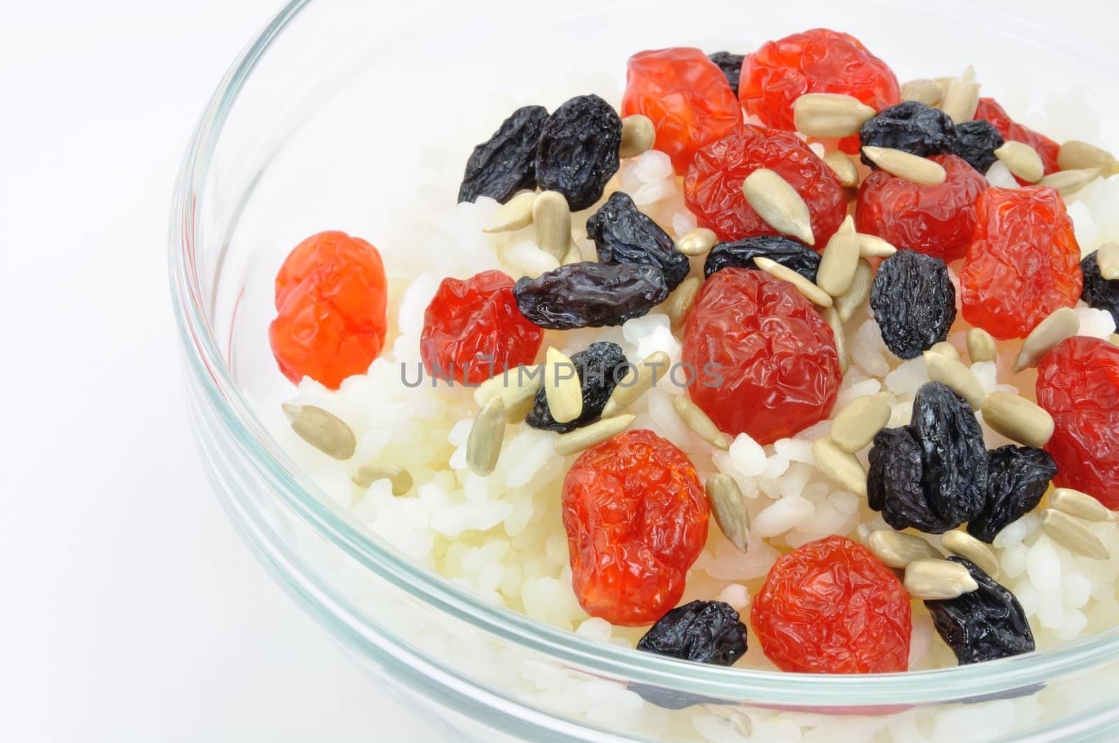 Boiled White Rice with Dried Fruit and Sunflower Seeds in Transparent Bowl on White Background Close-Up