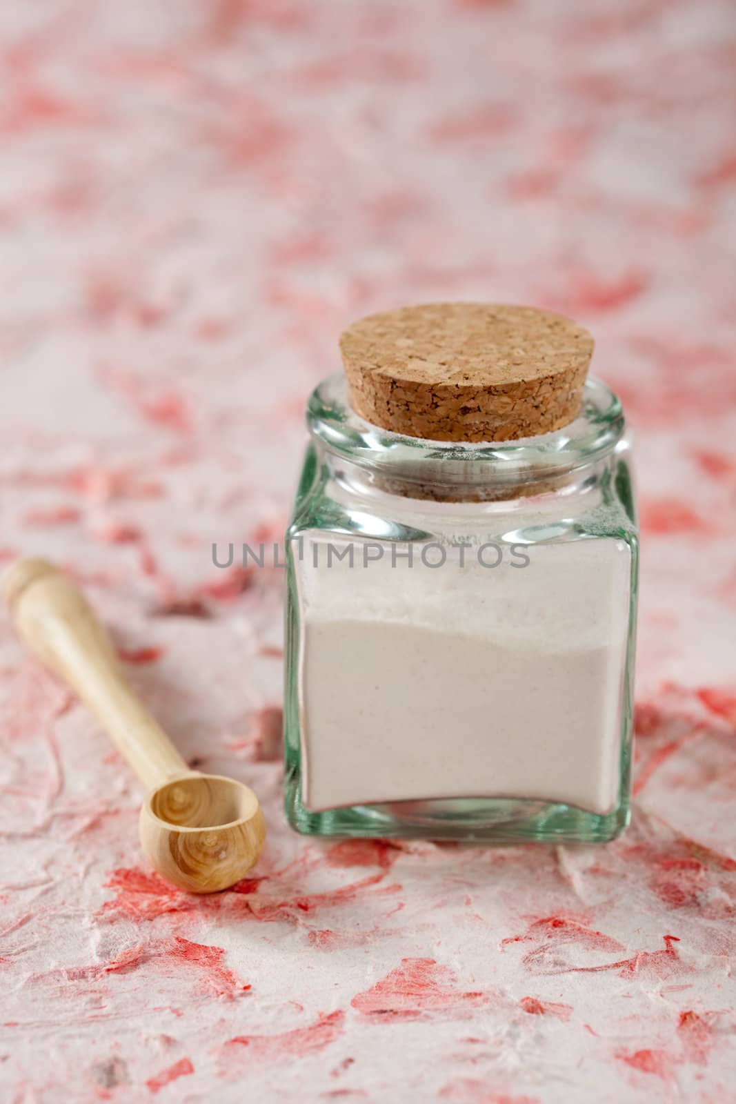 Small jar of flour with a little wooden spoon