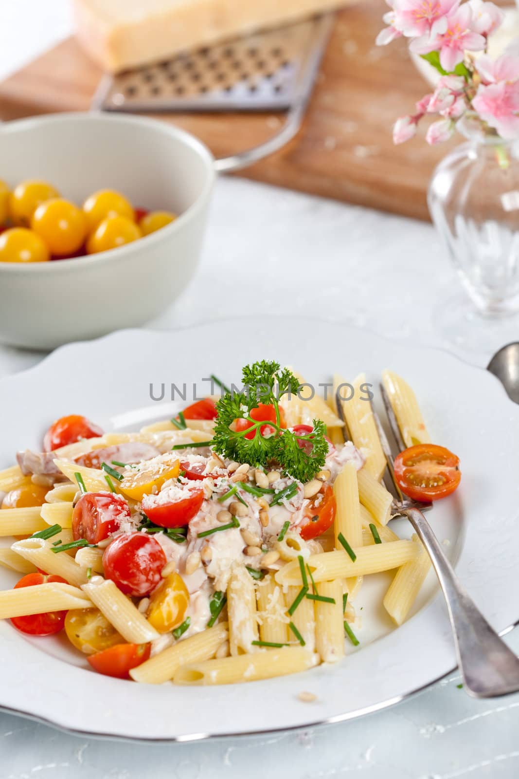 Delicious and fresh pasta with tomatoes, chives and parsley