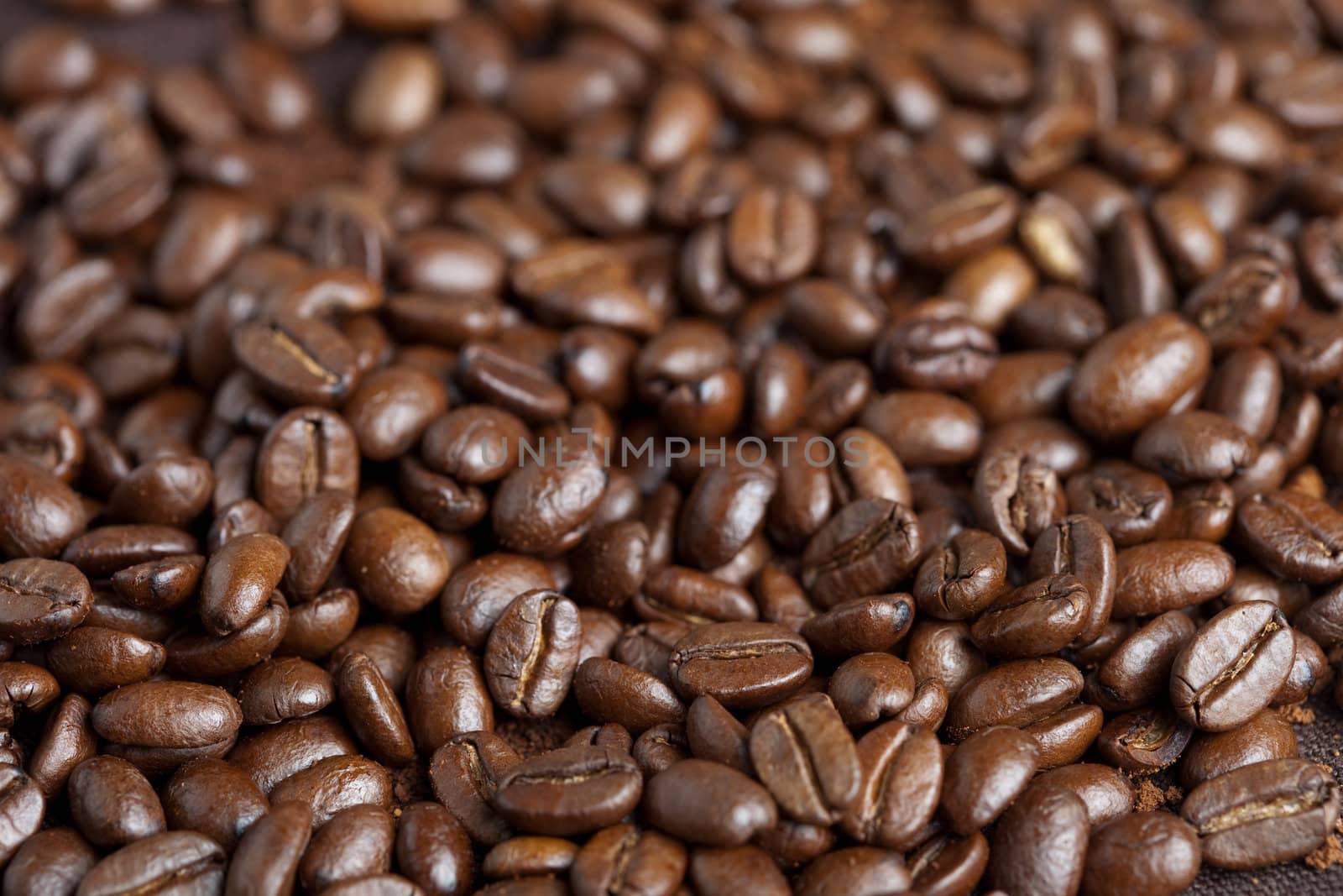 Pile of roasted coffee beans looking dark and lovely