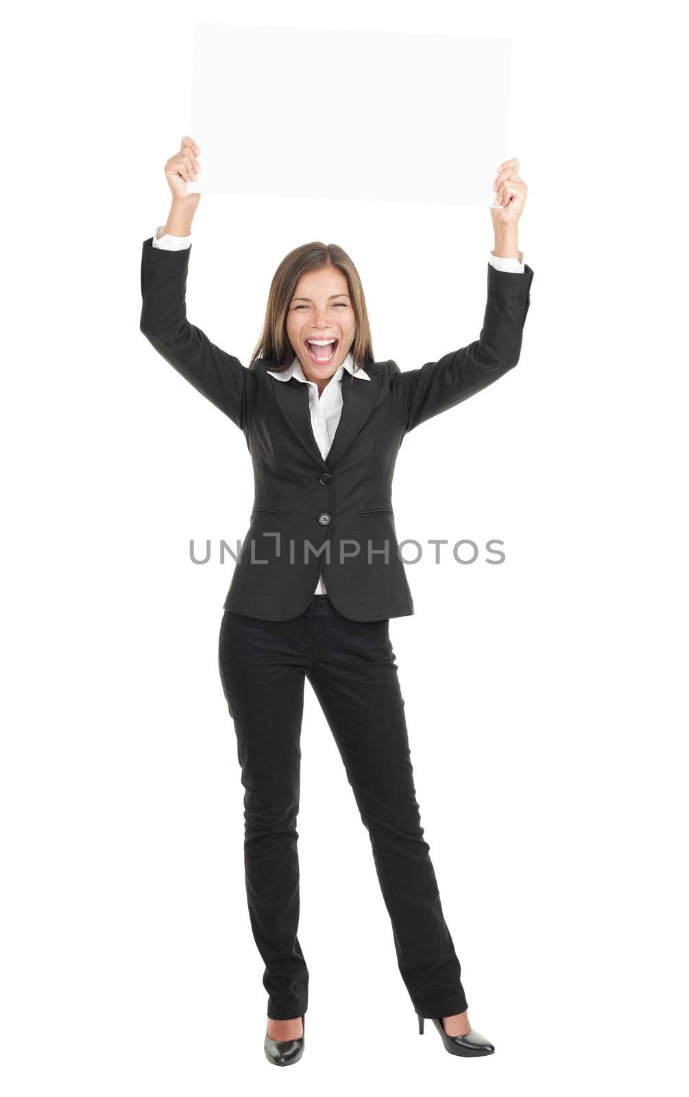 Businesswoman holding a white empty banner or sign board in full length while being very happy and excited. Beautiful mixed race chinese / caucasian woman isolated on white background. 