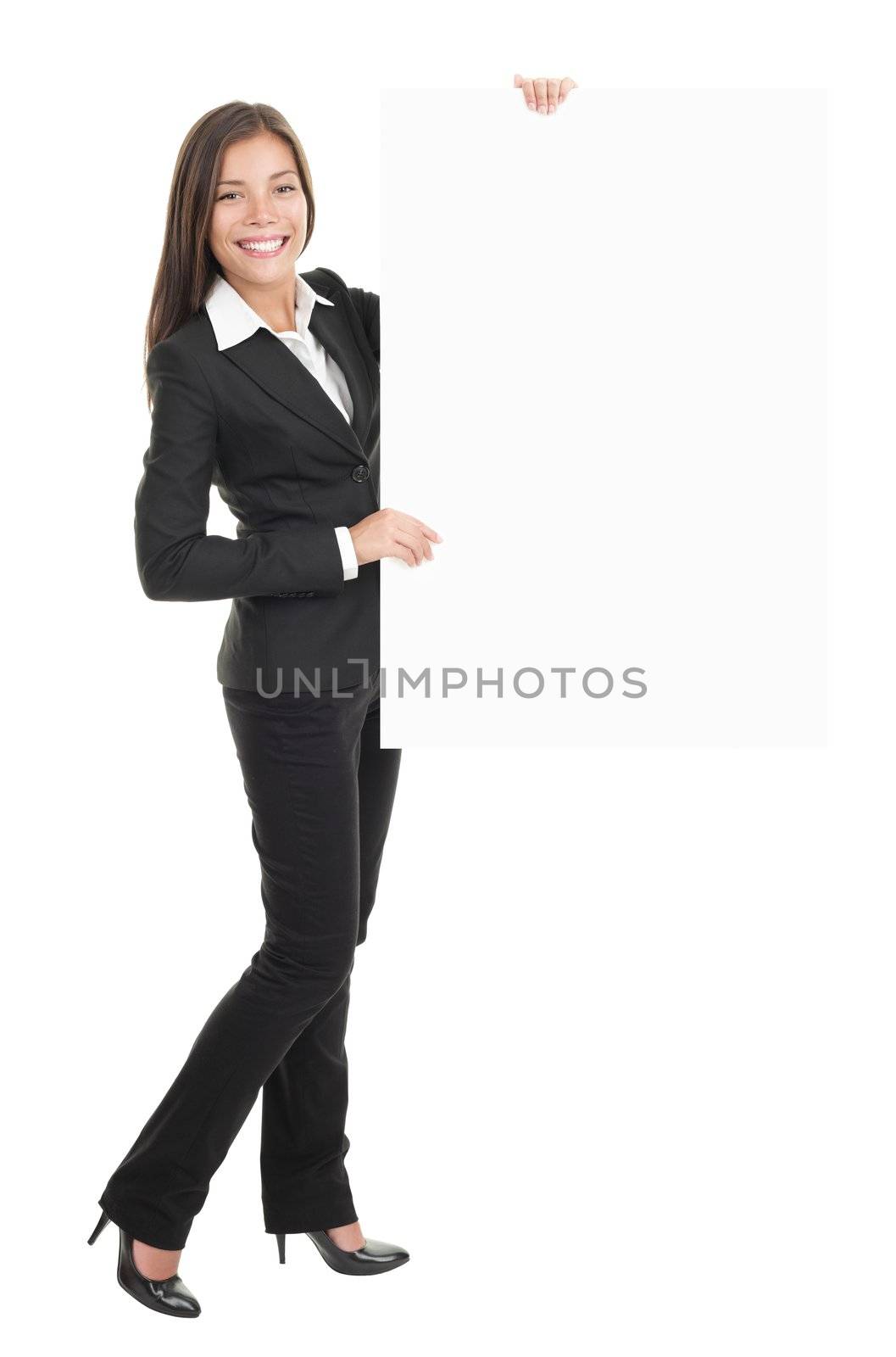 Businesswoman standing and holding a white empty billboard or signboard in full length. Beautiful mixed race chinese / caucasian woman isolated on white background. 