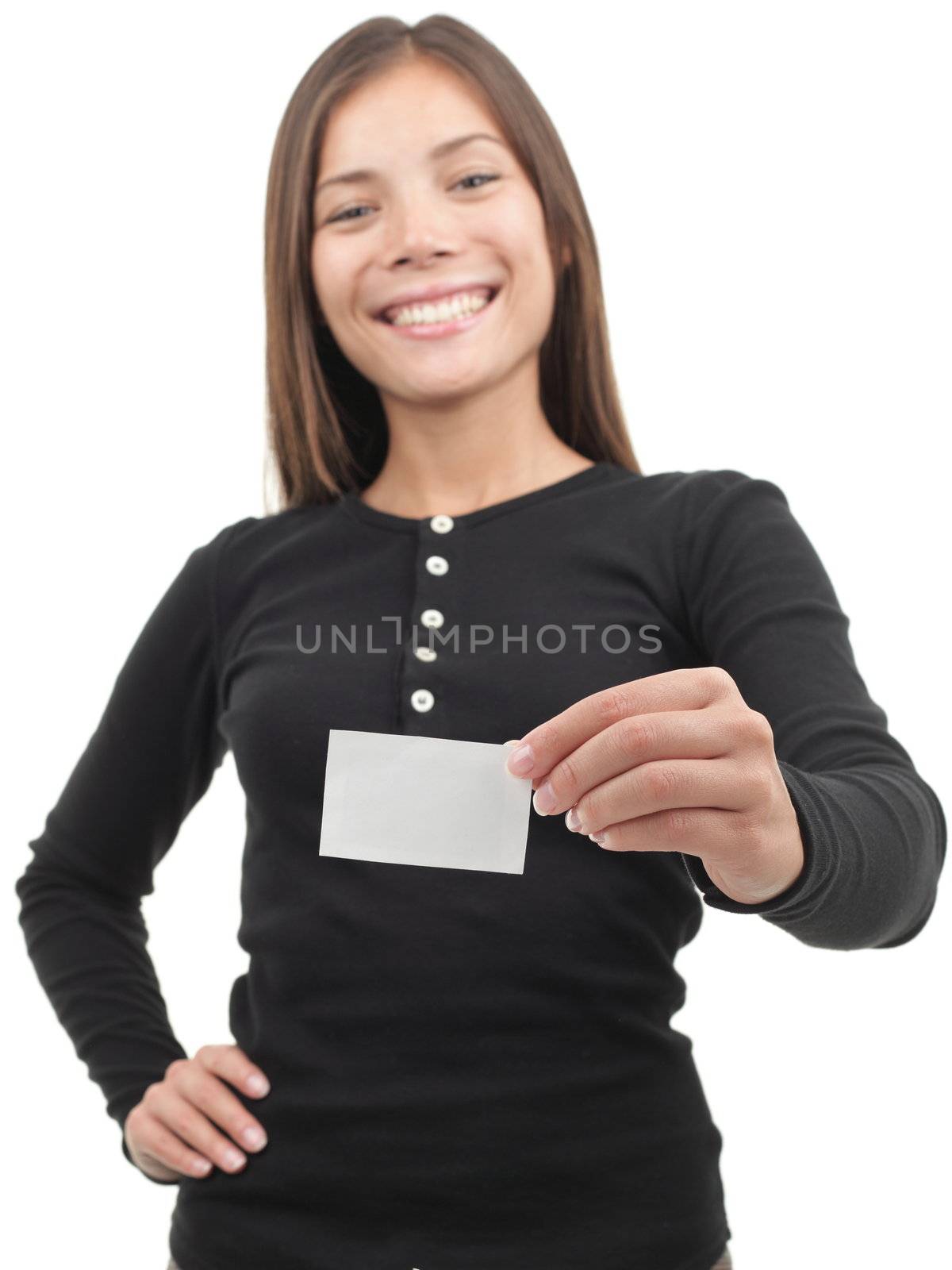 Young casual professional showing blank white business card / paper sign. Beautiful young mixed race chinese / caucasian woman. Isolated on white background. Shallow depth of field, focus on card.