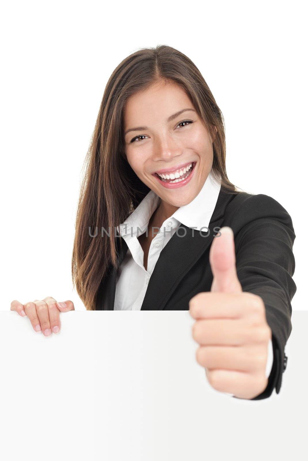 Businesswoman leaning over billboard sign giving thumbs up. Beautiful mixed race chinese / caucasian woman. Isolated on white background. 