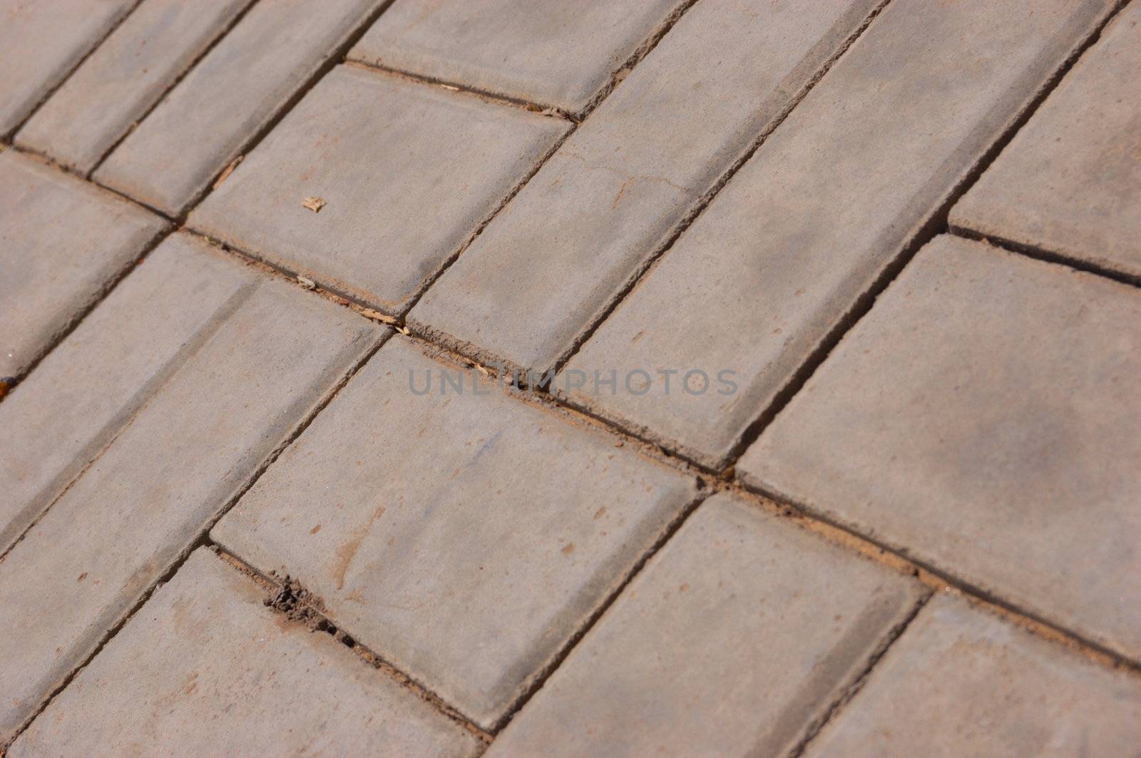 close-up new pavement of stoneblocks (bricks) of grey color