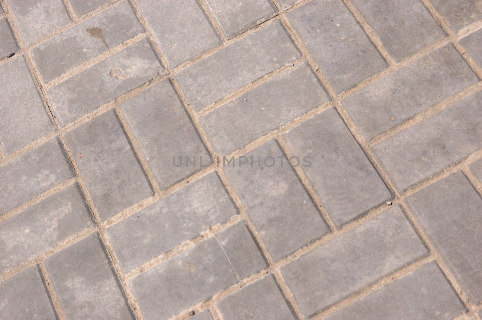 close-up of new pavement of stoneblocks (bricks) of grey color
