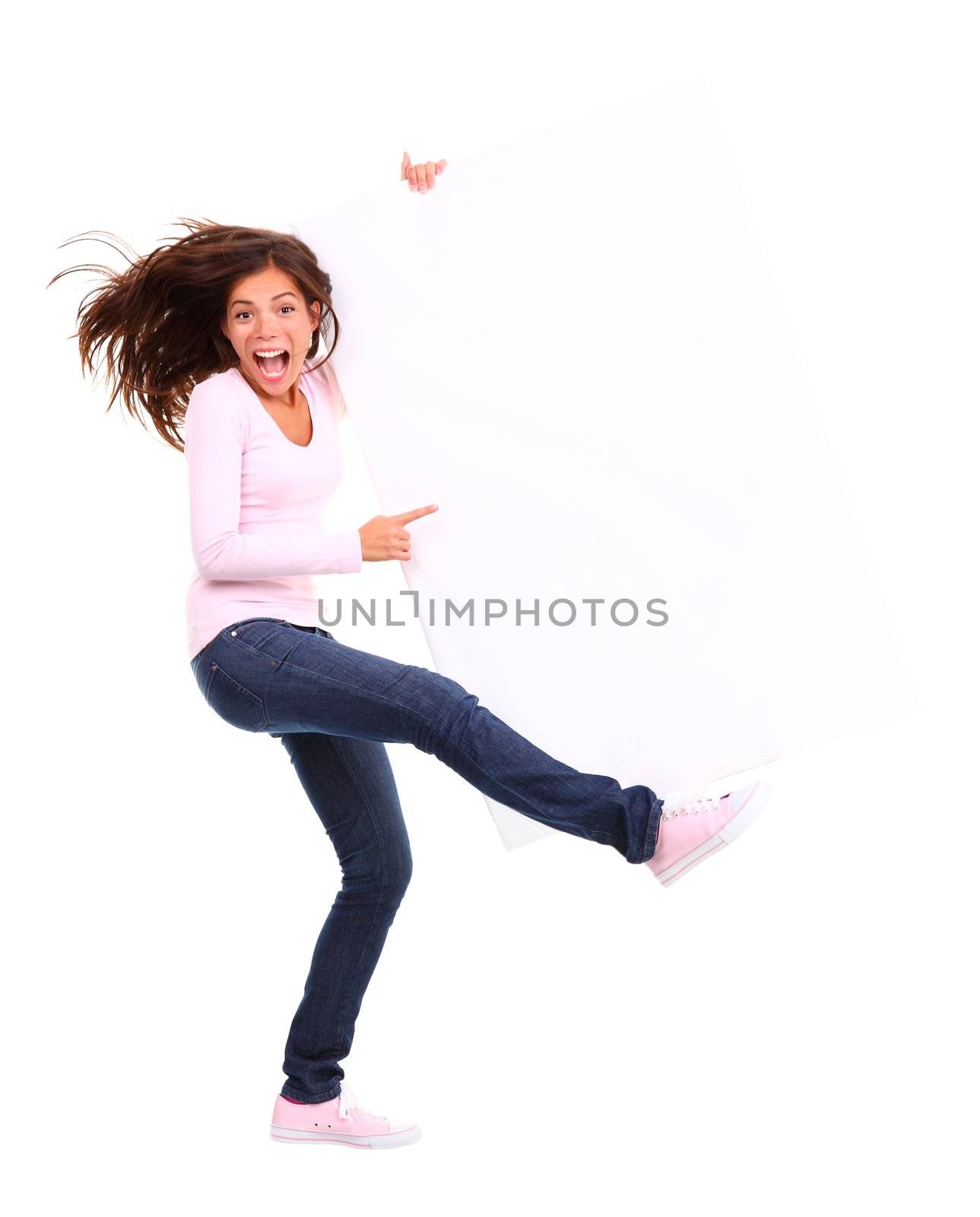 Excited woman holding sign. Funny and dynamic full length picture of woman holding a white blank billboard / placard. Beautiful mixed race chinese / caucasian model. Isolated on white background.