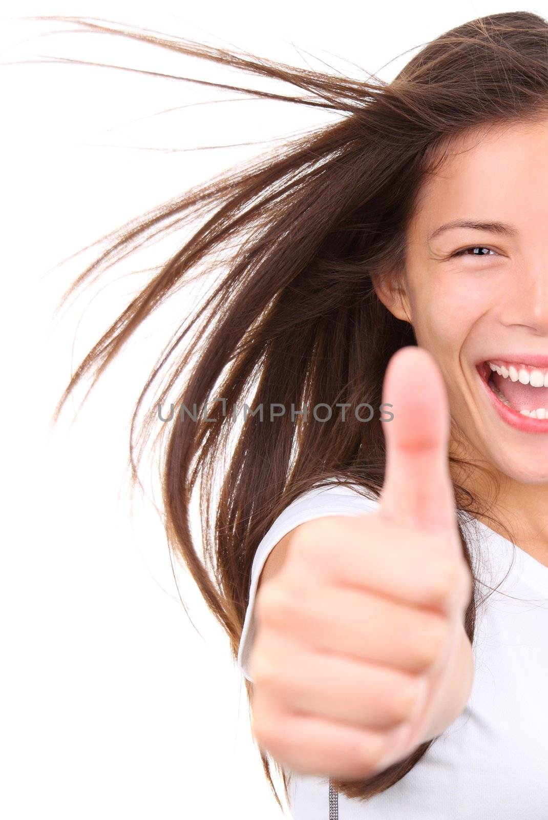 Happy woman with fresh look giving a thumbs up. Isolated on white background. Mixed race chinese / caucasian model.