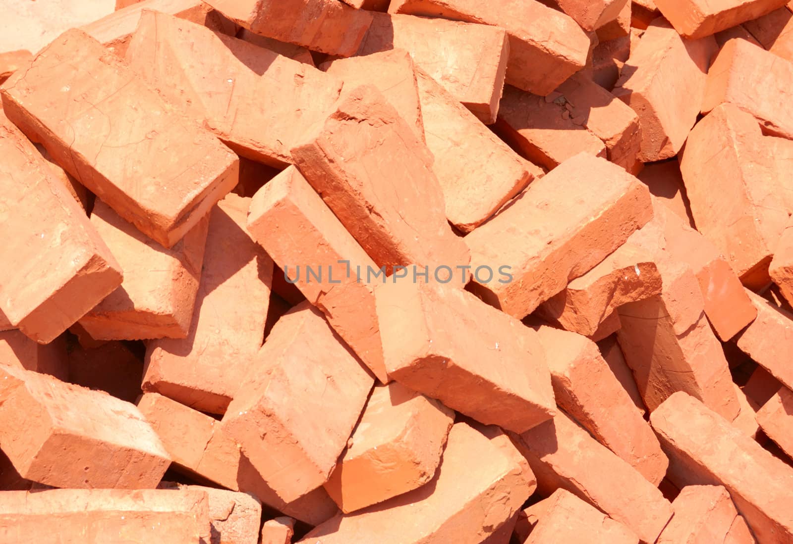 heap of baked bricks with red surface