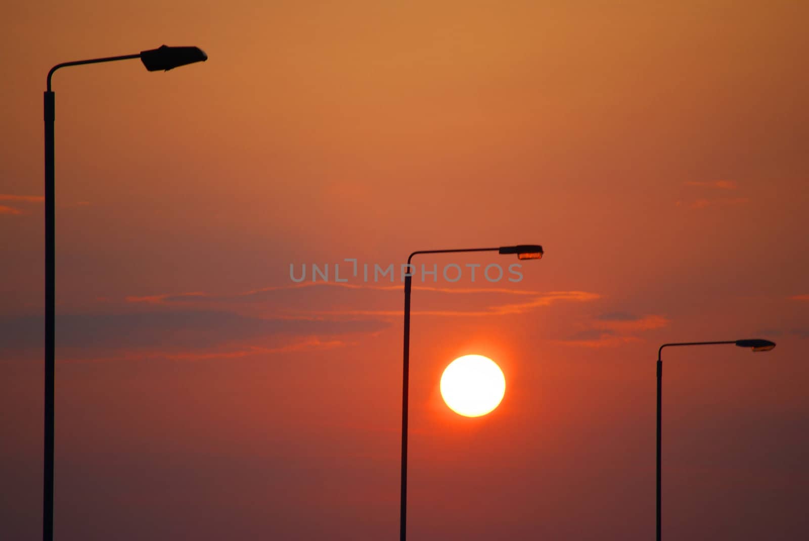 silhouettes of streetlamps in the light of a beautiful sunset