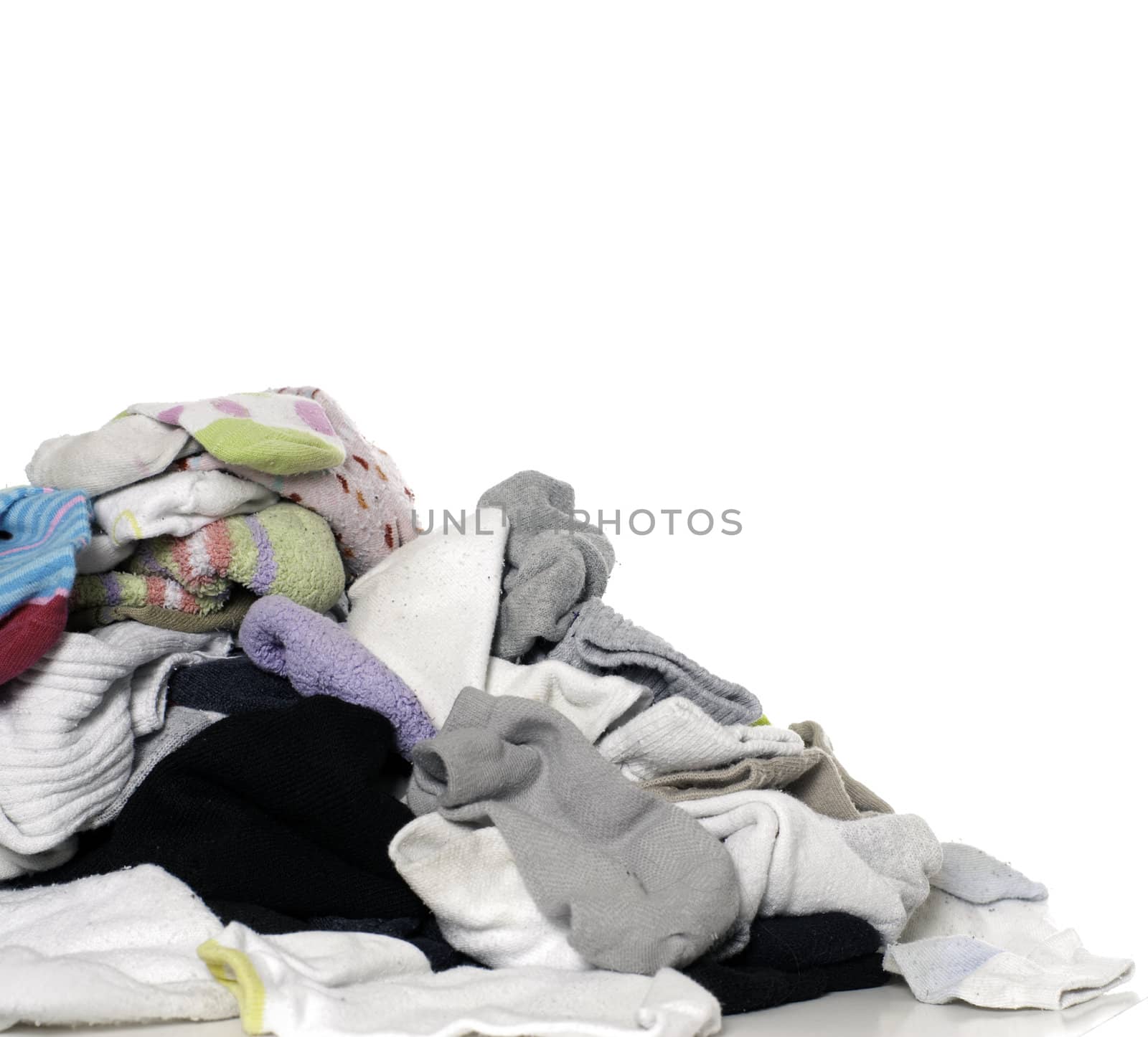 A pile of clean unsorted laundry, isolated against a white background