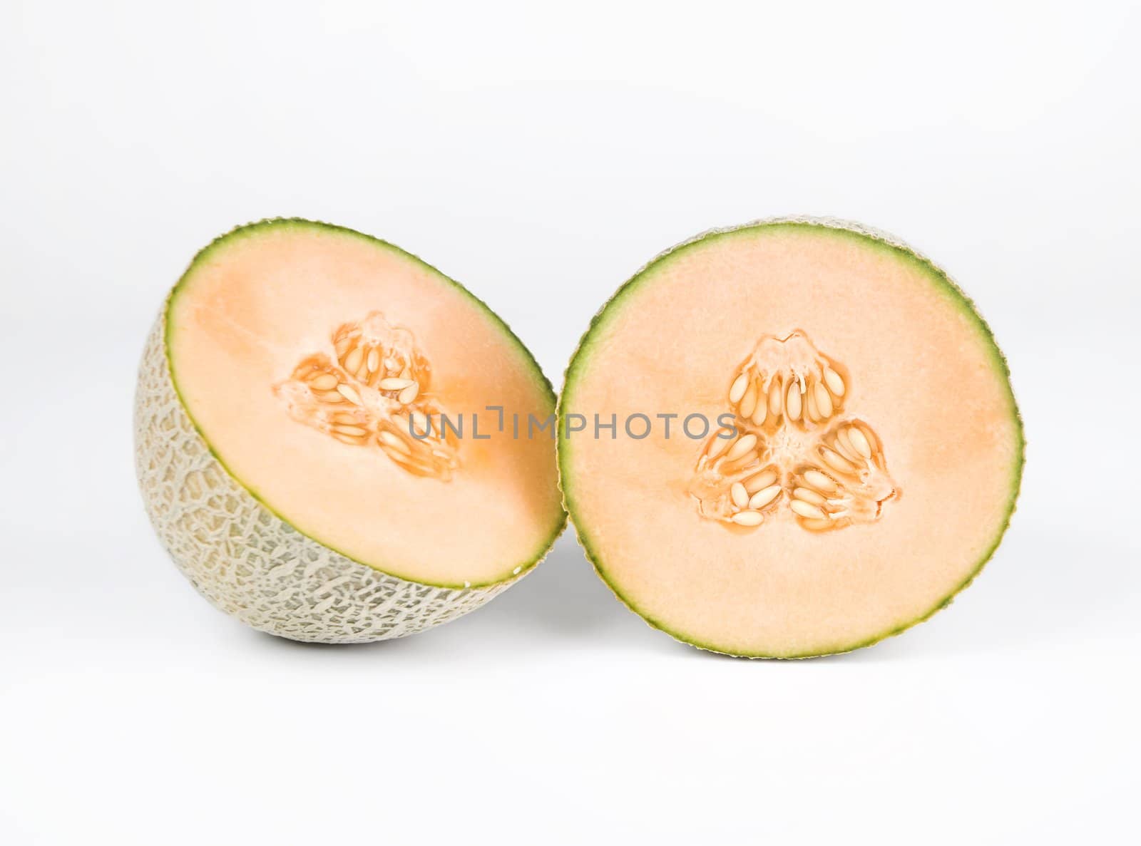 Halved cantelope isolated on a white background