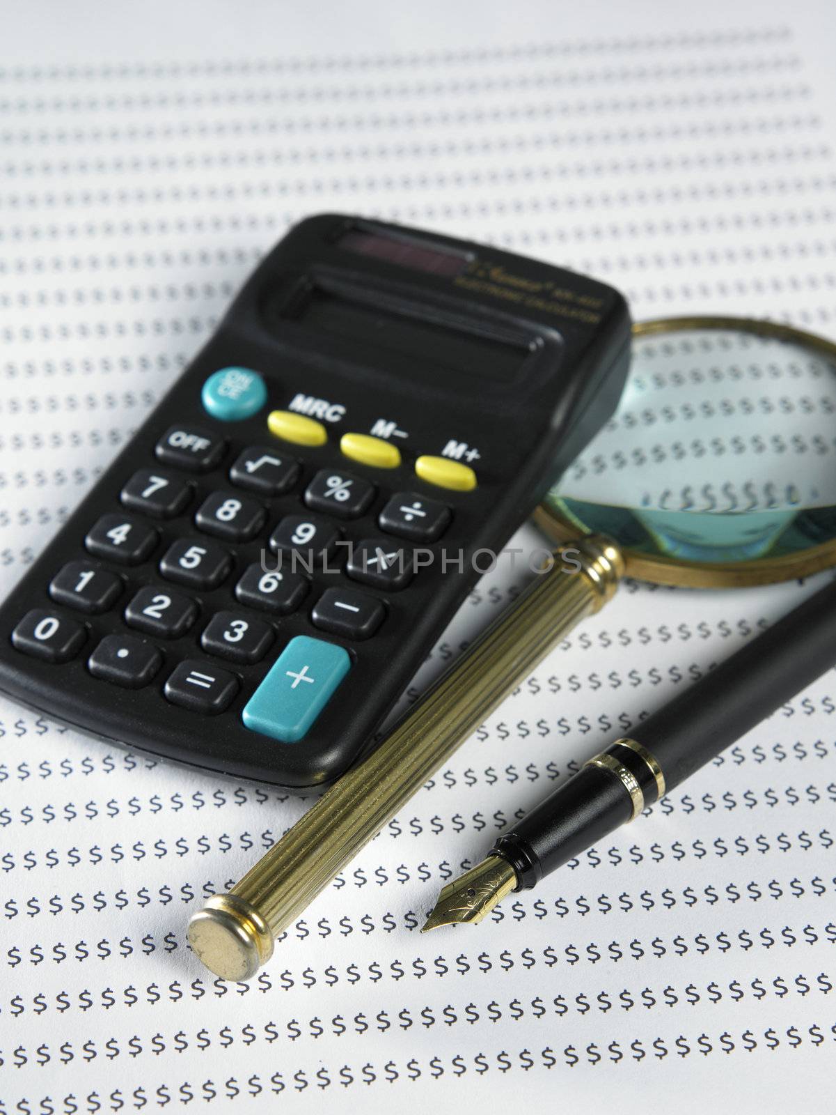 close up of the calculator,pen and magnifying glass