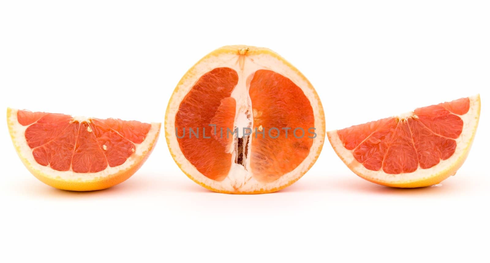 The cut grapefruit on a white background