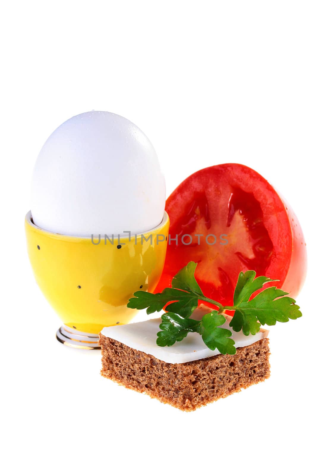 Egg in a yellow support with bread, bacon and tomato.