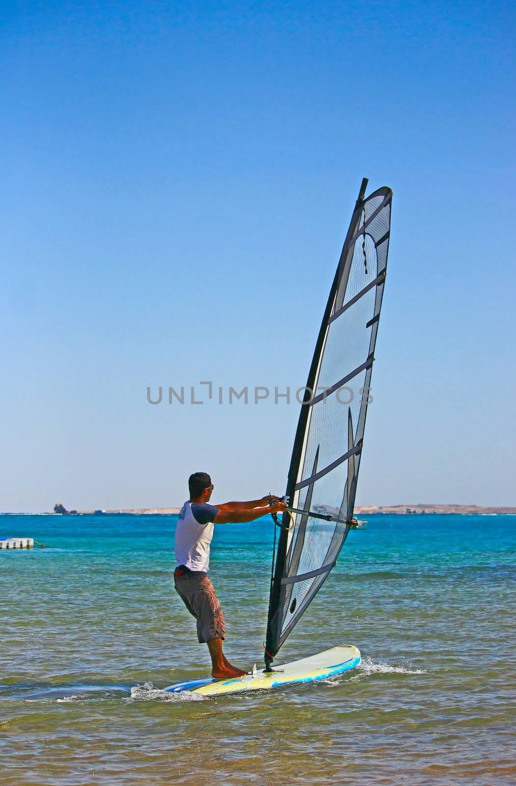Egypt. Fast moving windsurfing on the background of the sea.