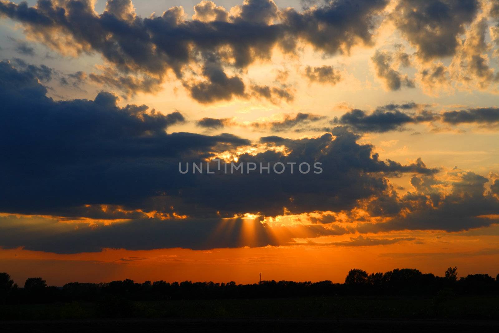 sun behind dark clouds in sky by Mikko
