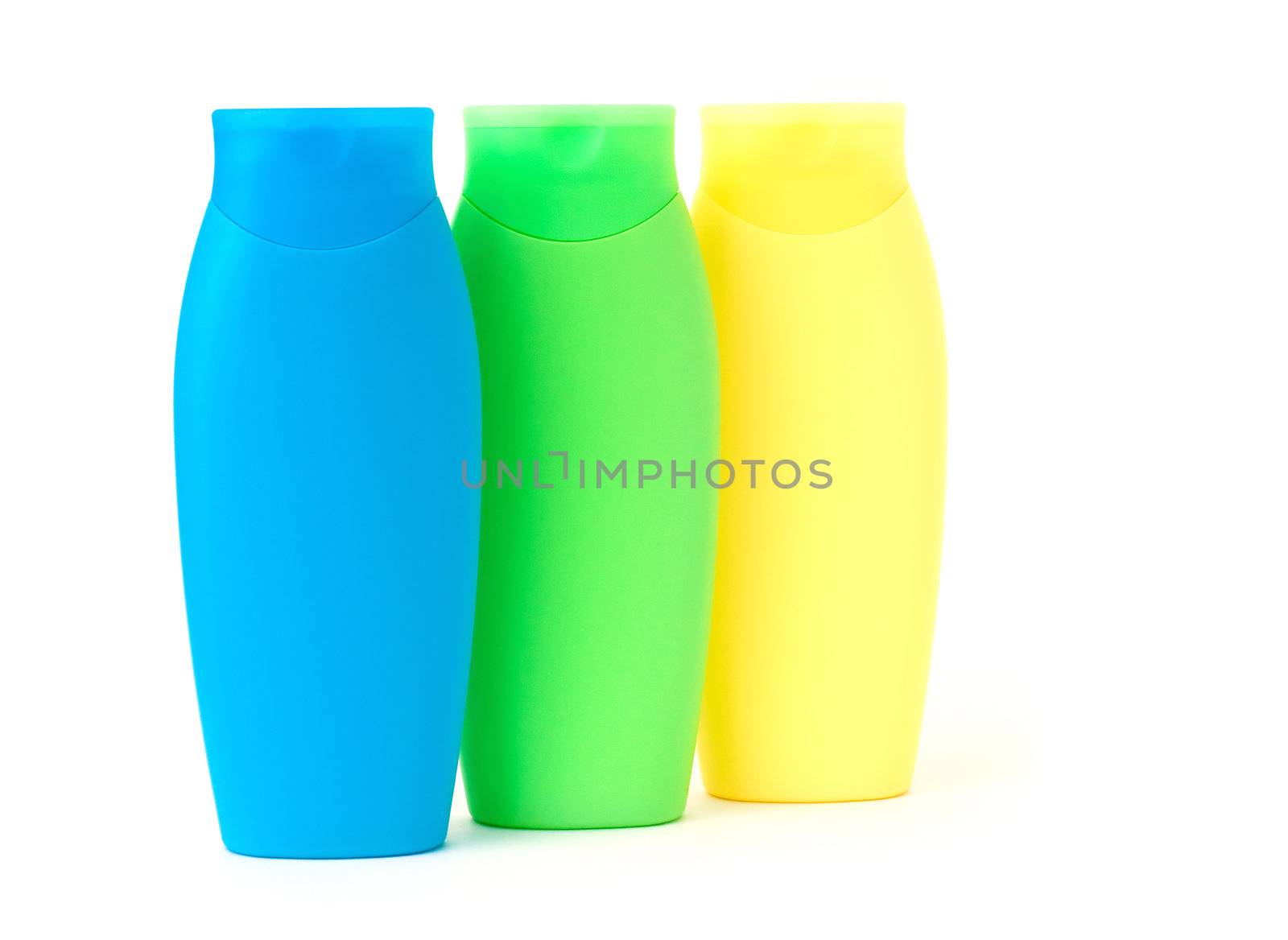Colorful bottles with shampoo on white background