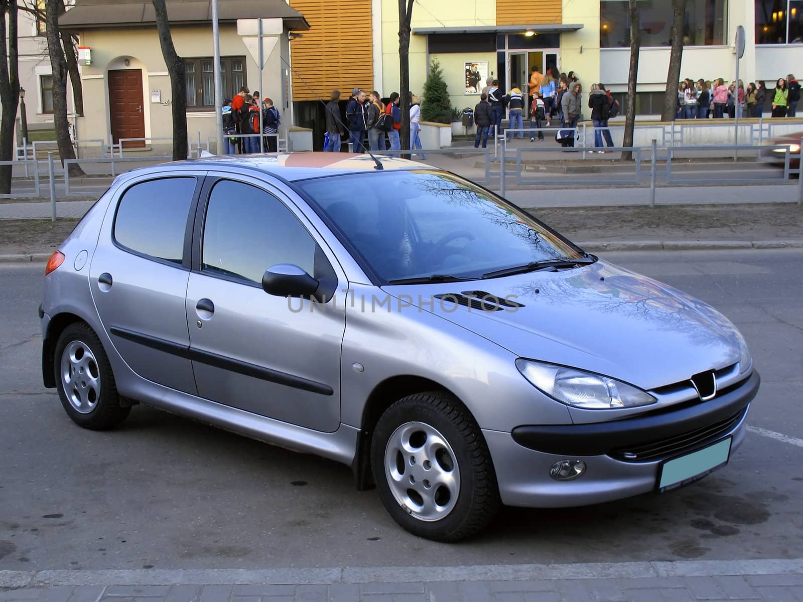 Small car parked near nihgt club.