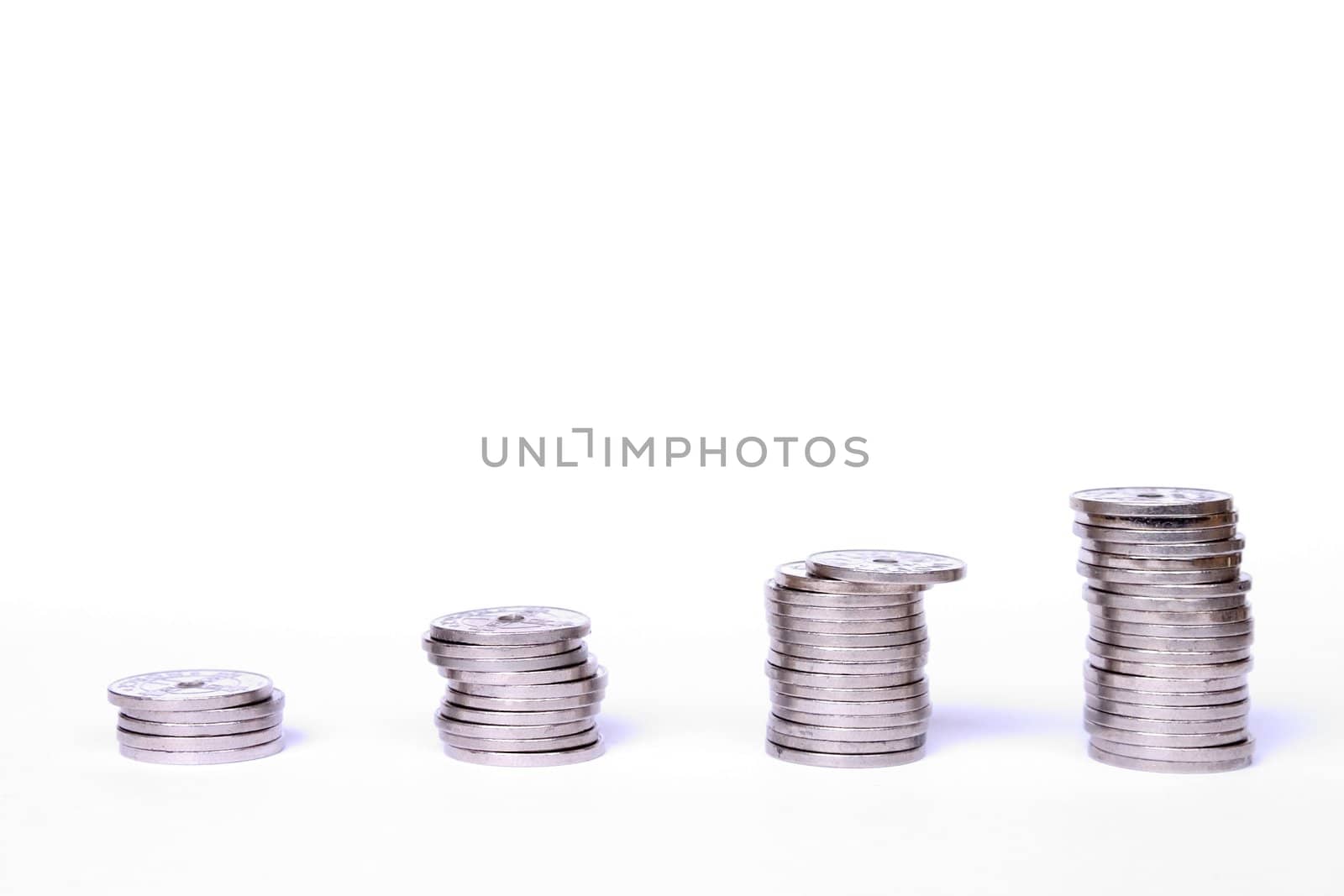 Stacks of coins on white background. Norwegian coins used in the picture.