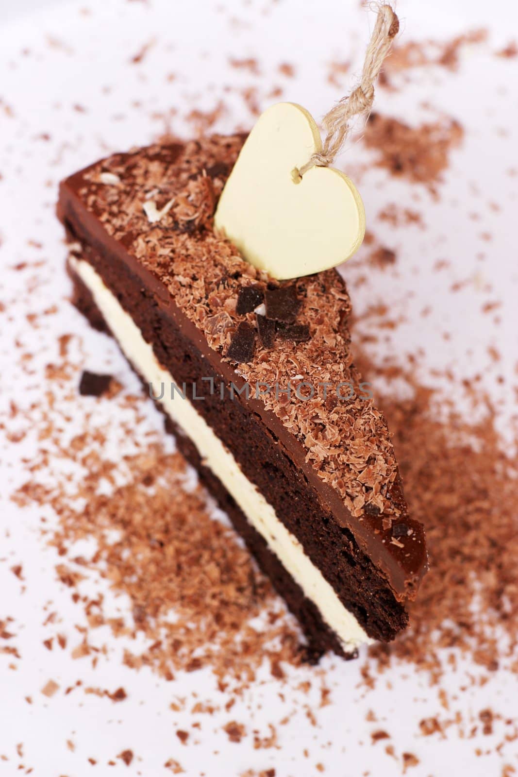 Closeup of a chocolated cake with heartshaped accessory on top