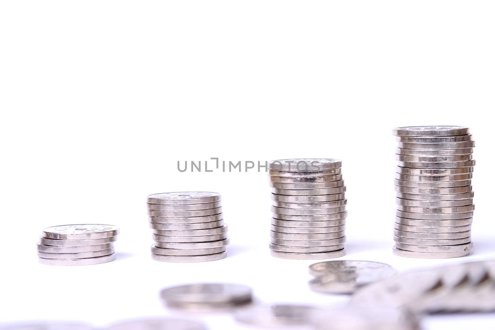 Stacks of coins isolated on white background.