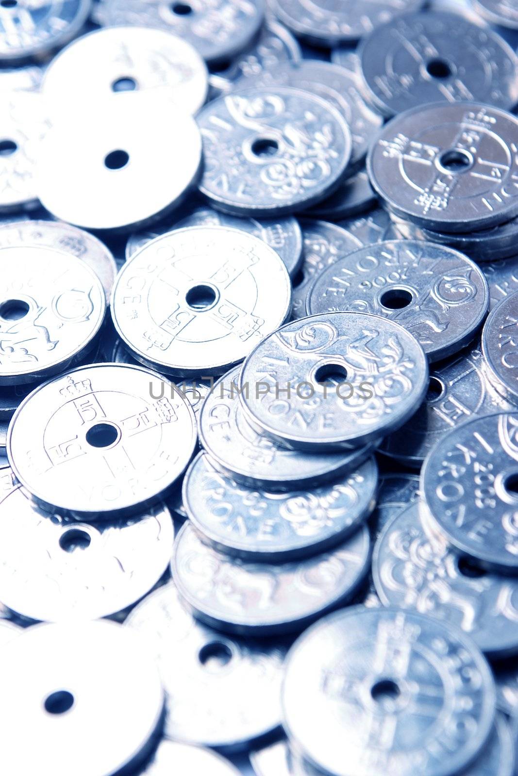 Closeup of coins (Norwegian) with a blue color