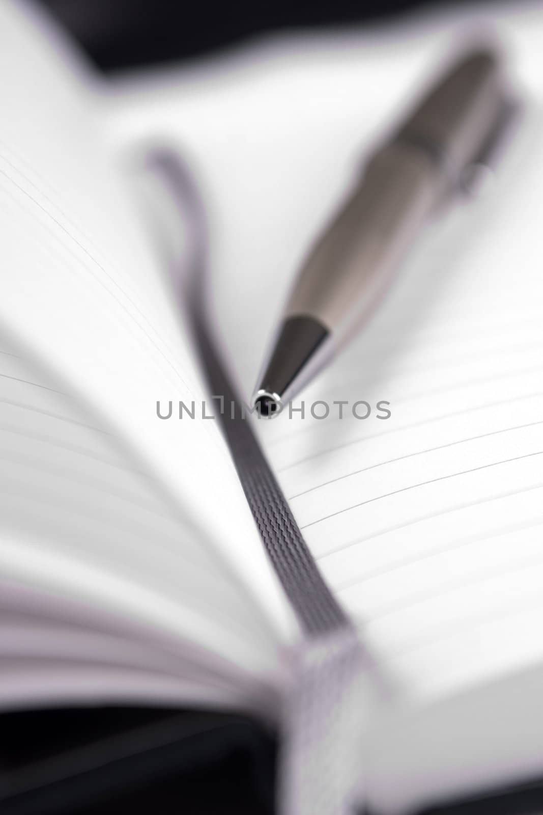 A notebook and pen. Photographet with a small depth of field.