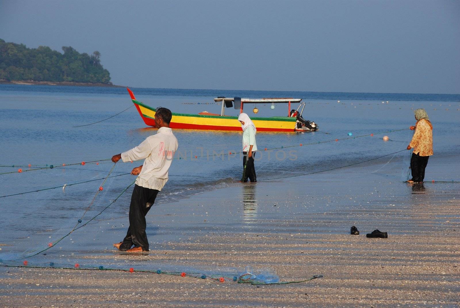 People fishing with nets from a beach