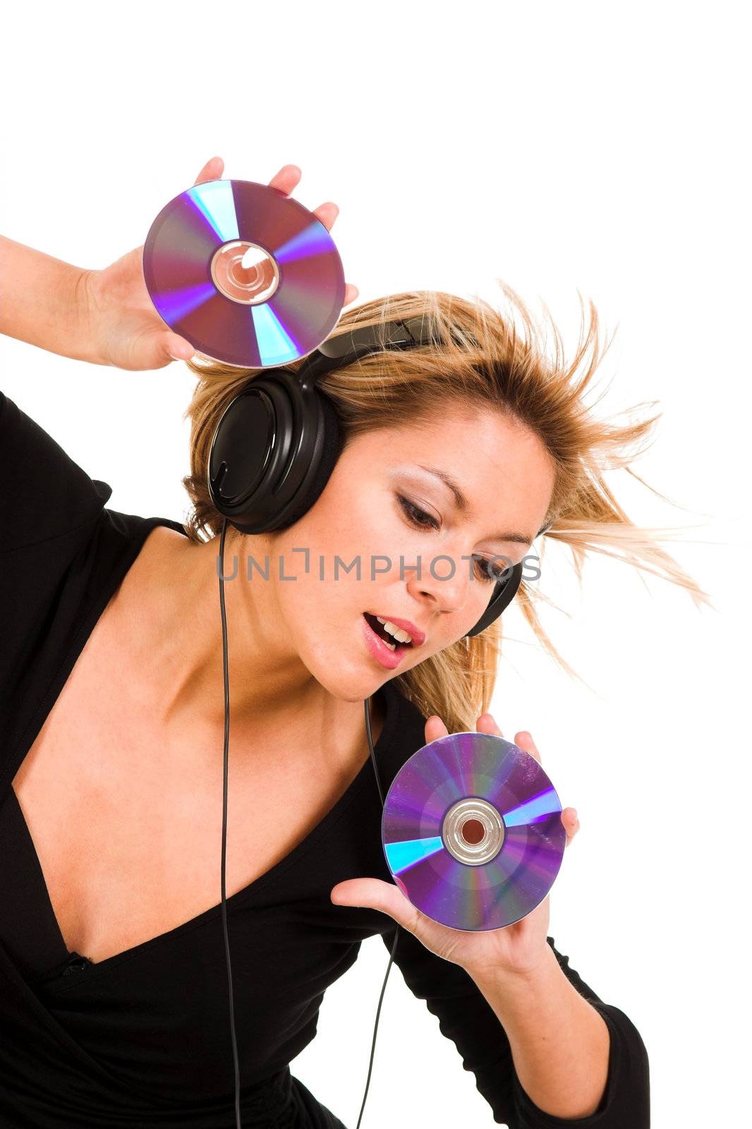 beautiful young woman listening music in headphones and holding two CD 