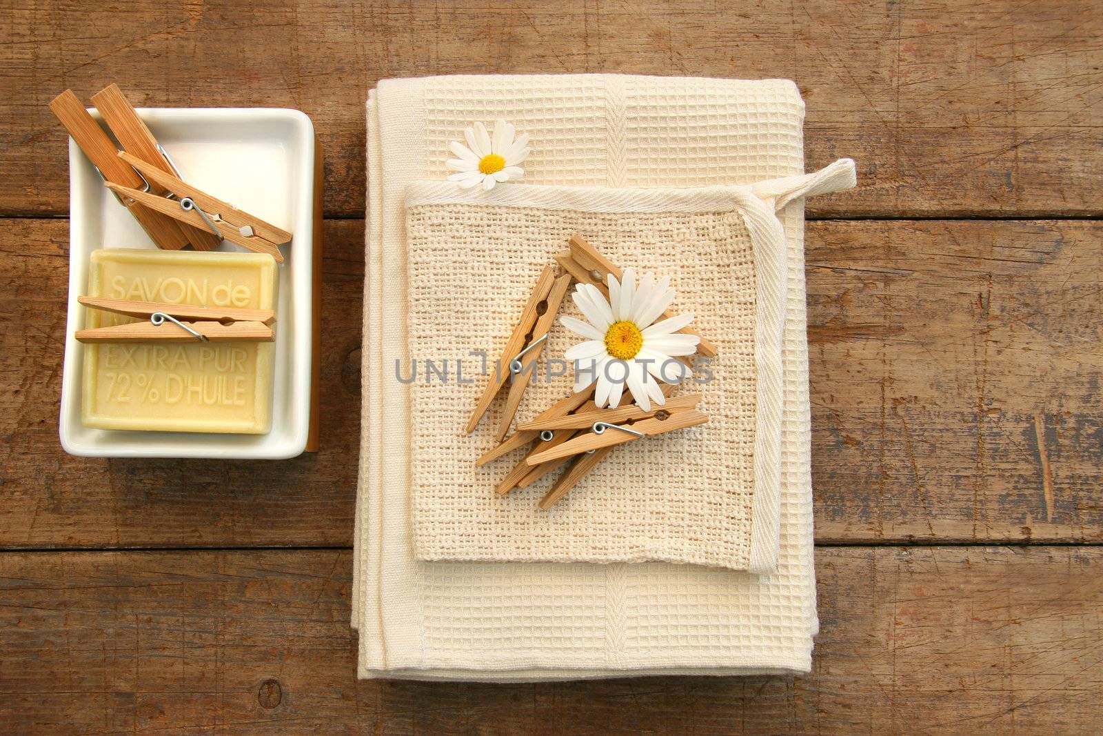 Soap, clothespins and towels on rustic table