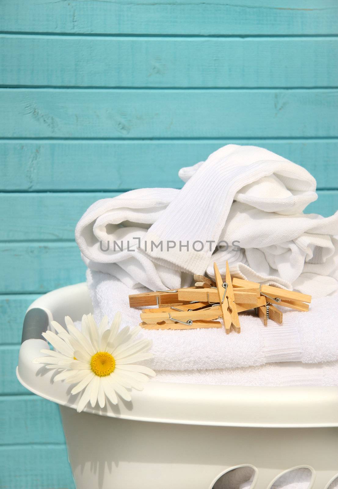 White  basket with laundry by Sandralise