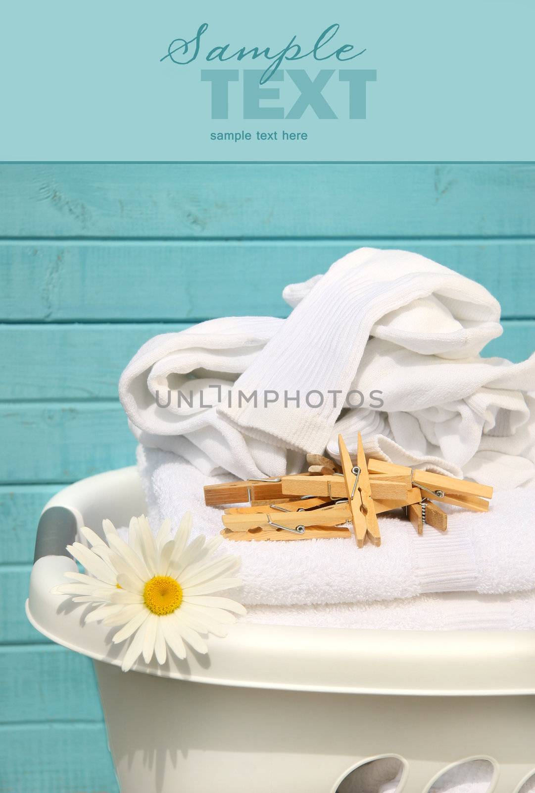 White laundry basket with folded towels and socks