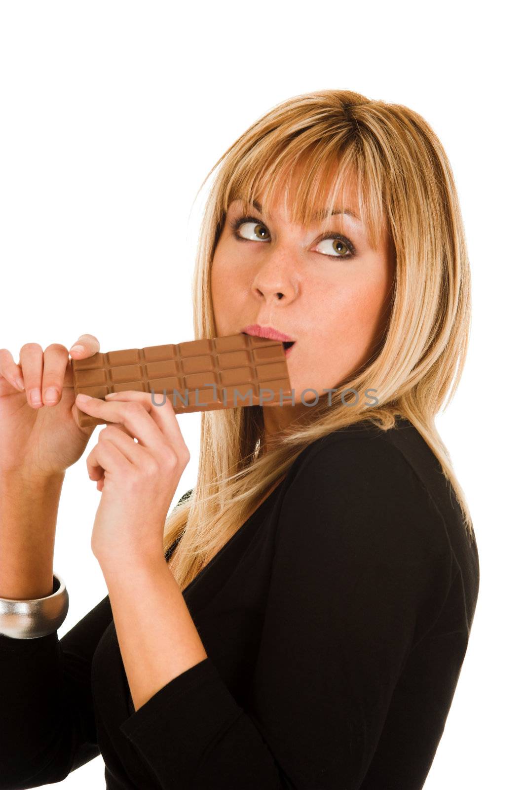 young girl eating chocolate on white background