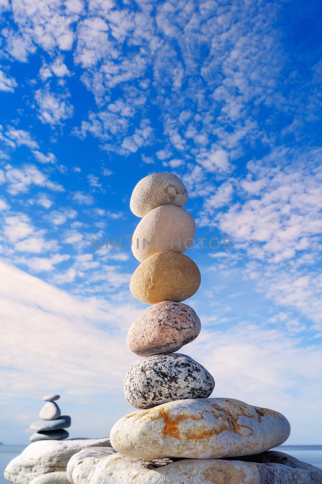 A stack of the round pebbles against the cloudy sky